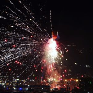 Low angle view of firework display at night