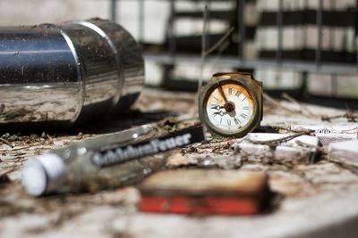 Close-up of abandoned navigational compass on dirty table