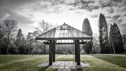 Gazebo by trees against sky