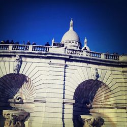 Low angle view of historical building against clear blue sky