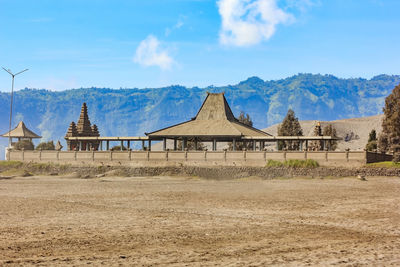 Built structure on landscape against sky