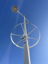 Low angle view of security camera against blue sky