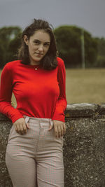 Portrait of young woman sitting outdoors