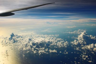 Aerial view of airplane wing against sky