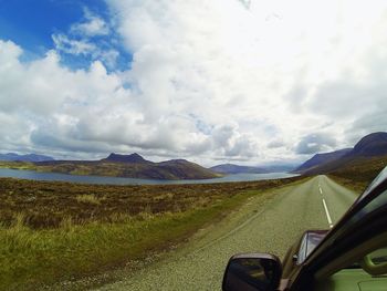 Scenic view of landscape against cloudy sky