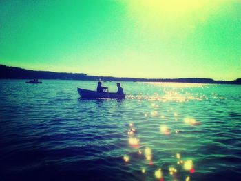 Boat in sea at sunset