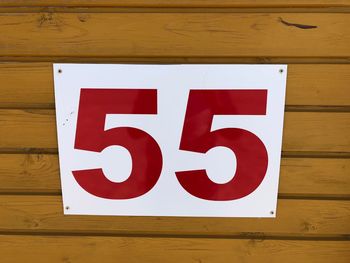 Close-up of number 55 on wooden wall