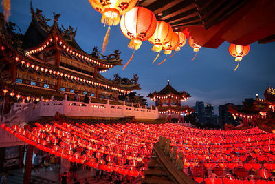 Low angle view of illuminated lanterns against sky