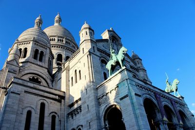 Low angle view of church against blue sky