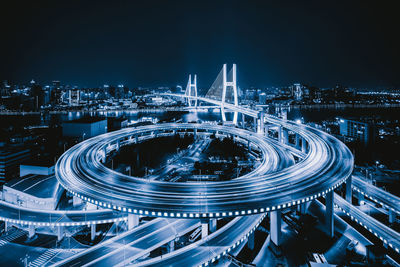 High angle view of light trails on city street at night