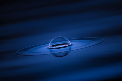 Close-up of drop on blue water