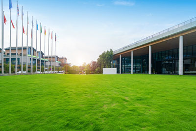 Lawn by building against sky