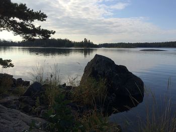 Scenic view of lake against sky at sunset