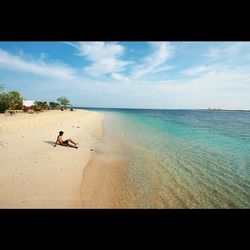 Man on beach against sky