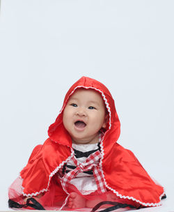 Portrait of cute girl in snow against white background