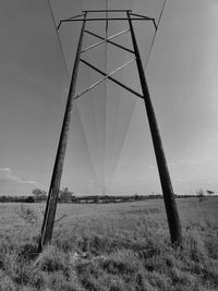 Metallic structure on field against sky