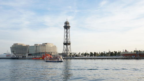 Boats in river with buildings in background