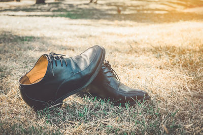Close-up of shoes on field