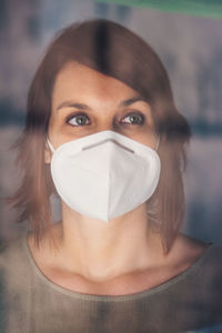 Close-up portrait of woman covering face