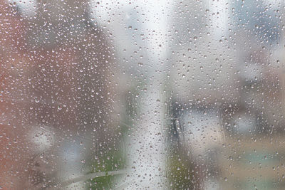 Full frame shot of raindrops on glass window