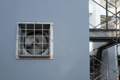 Low angle view of broken glass window of building