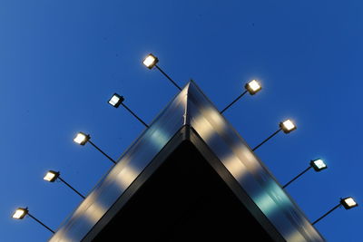 Low angle view of illuminated street light against sky