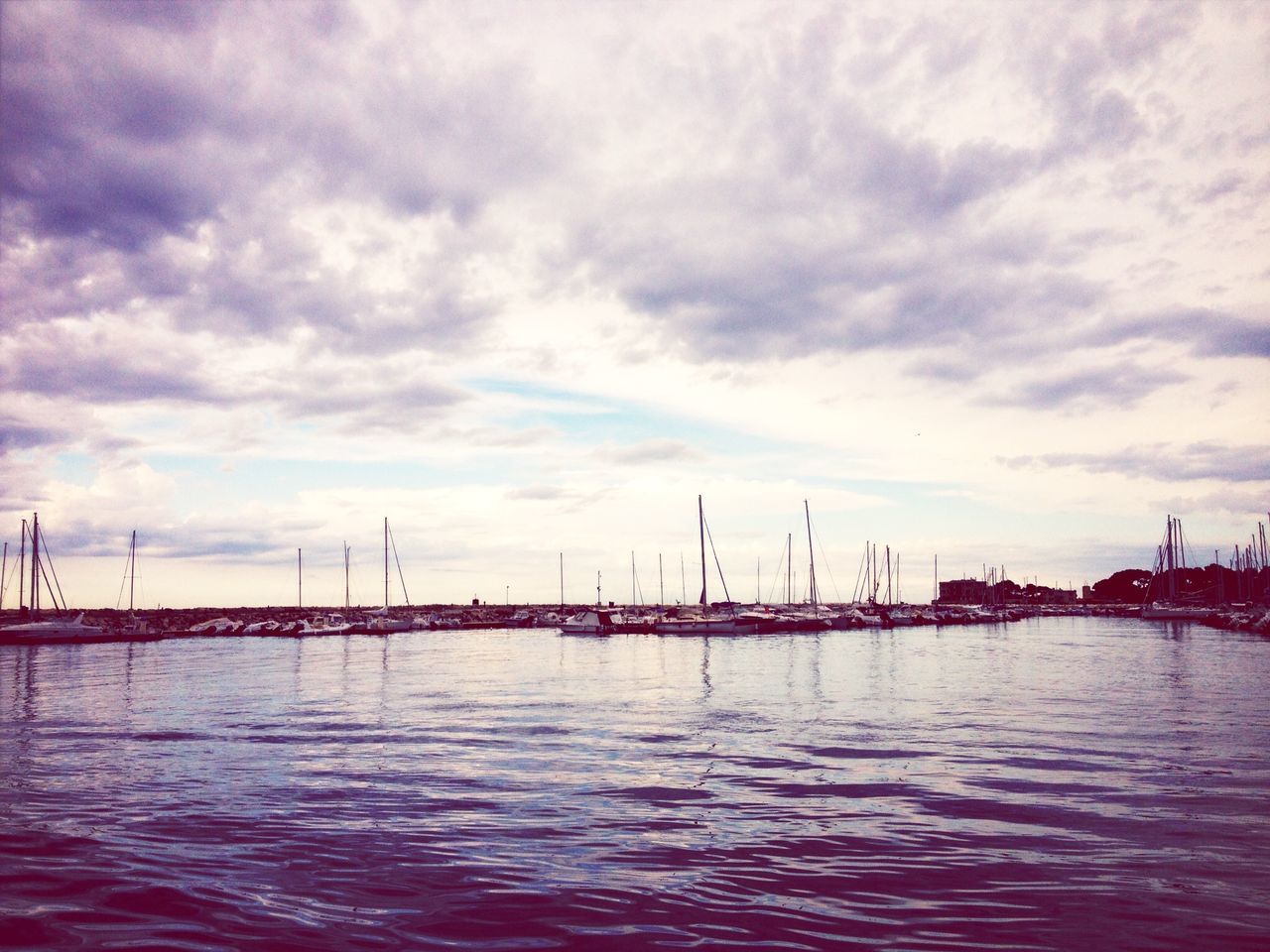 water, waterfront, sky, cloud - sky, sea, cloudy, nautical vessel, harbor, rippled, cloud, tranquility, nature, tranquil scene, transportation, commercial dock, scenics, river, dusk, outdoors, built structure