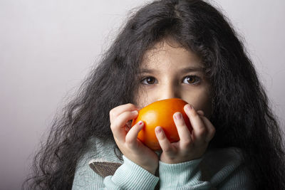 Portrait of young woman holding pumpkin