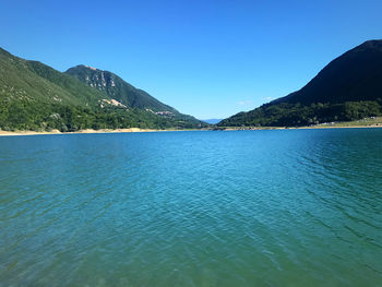 Scenic view of sea against clear blue sky