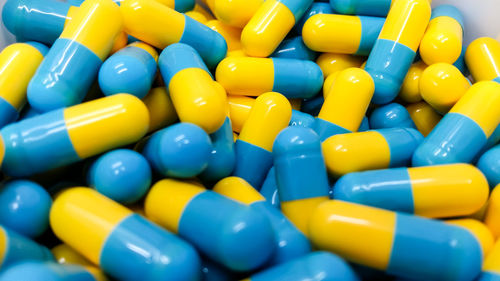 Full frame shot of blue and yellow capsules