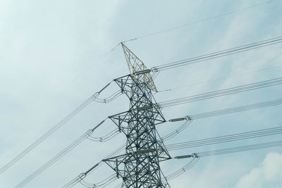 Low angle view of electricity pylon against sky