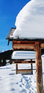 Built structure on snow covered field against sky