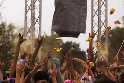 People enjoying with powder paint during music festival