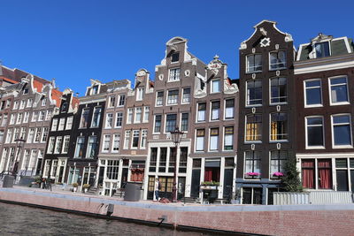 Low angle view of buildings against blue sky