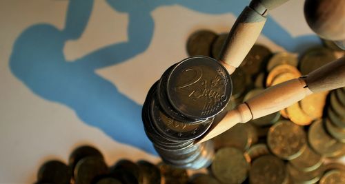 Close-up of coins and figurine on table