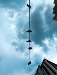 Low angle view of street light against building