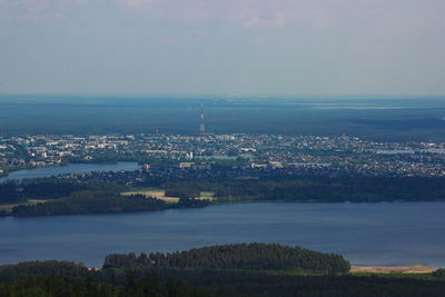 High angle view of buildings and sea against sky