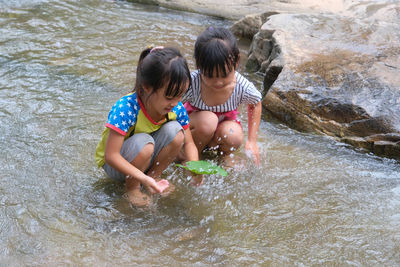 High angle view of boy playing in lake