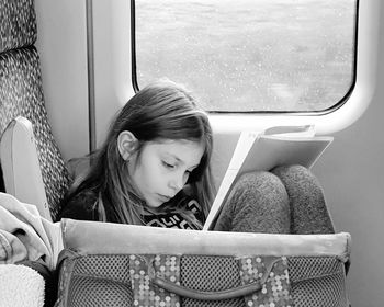 Girl sitting on seat in bus