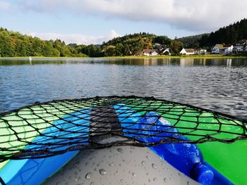 Scenic view of swimming pool by lake against sky