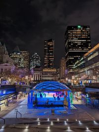 Illuminated buildings in city at night