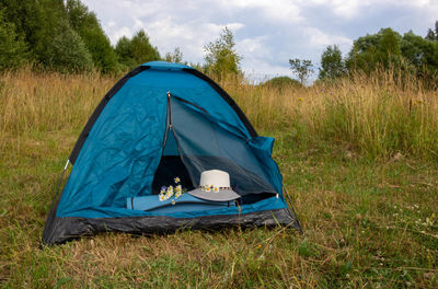 A tourist tent stands in a clearing. concepts of travel and adventure. background of nature.