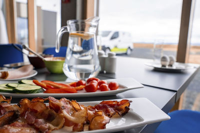 Close-up of healthy food served on dining table against window at restaurant