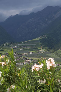 Scenic view of mountains and buildings against sky