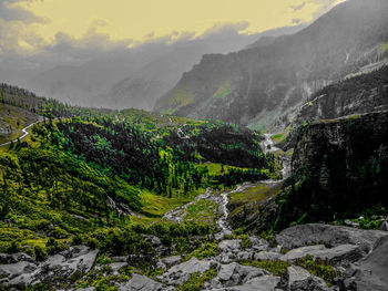 Scenic view of river and mountains against sky