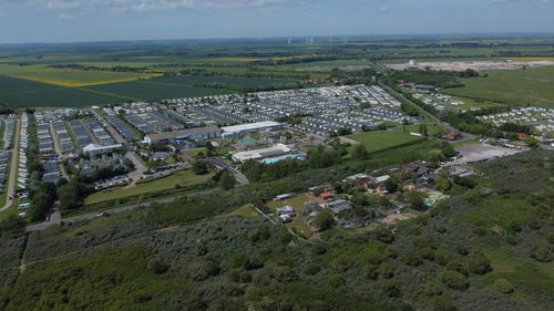 High angle view of houses on field by buildings