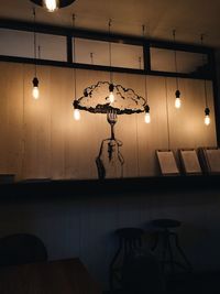 Low angle view of illuminated chandelier hanging from ceiling