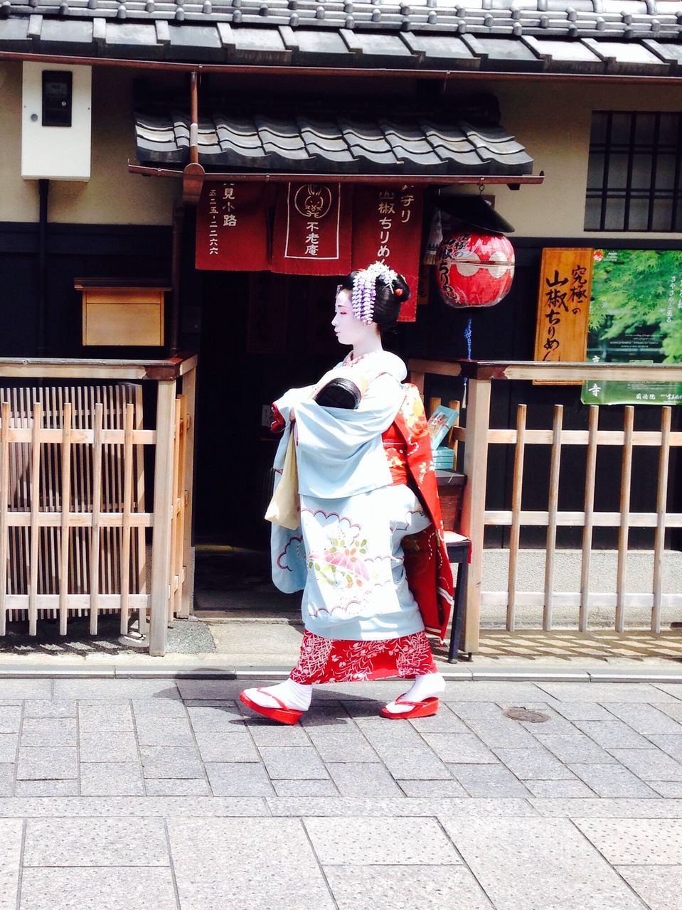 full length, built structure, building exterior, architecture, casual clothing, lifestyles, childhood, leisure activity, standing, front view, red, person, day, outdoors, elementary age, sidewalk, human representation, three quarter length