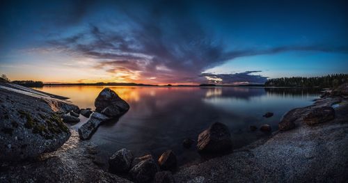Scenic view of lake against sky during sunset