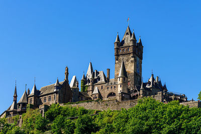 Low angle view of historic building against clear blue sky